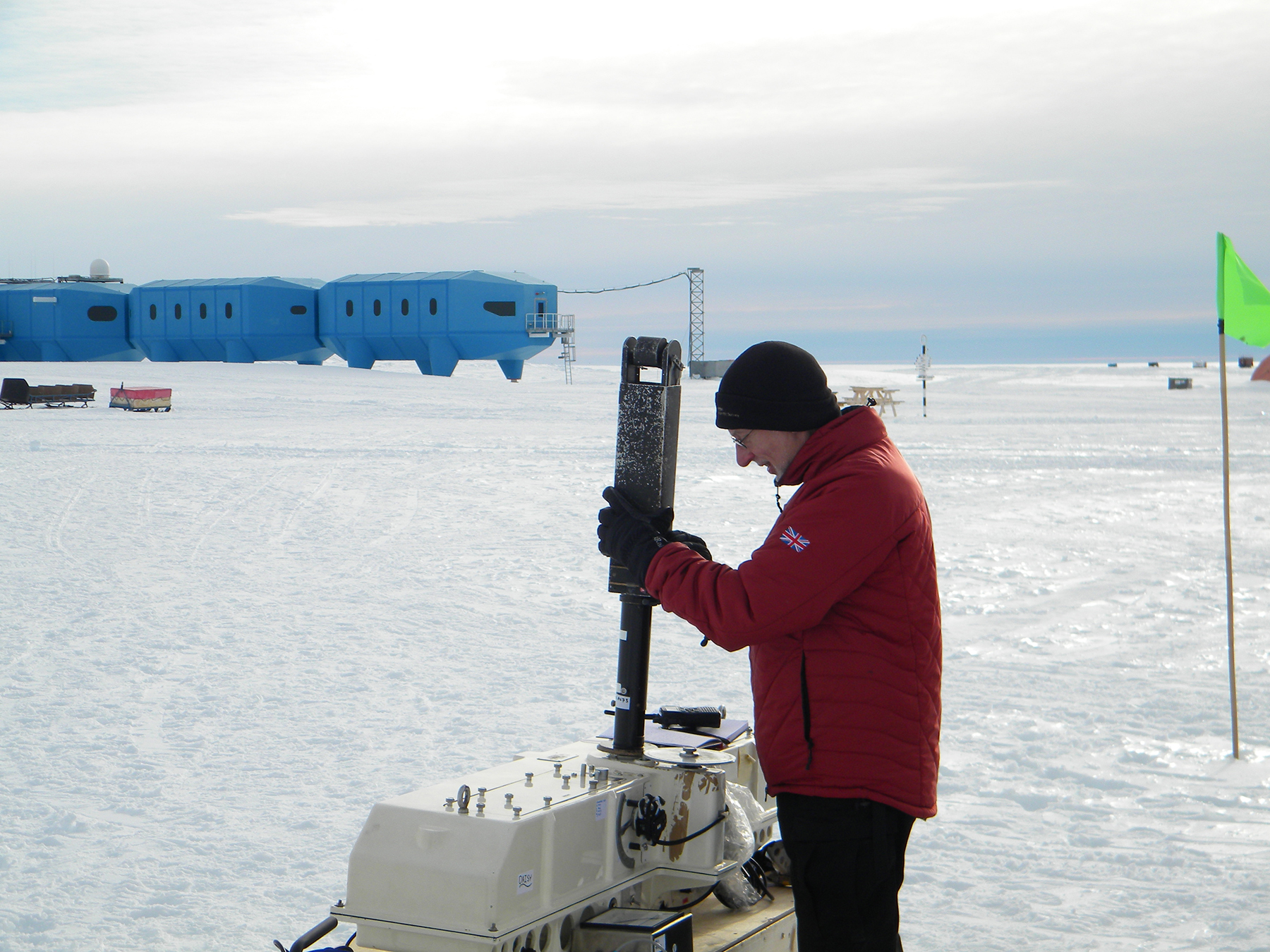 Using the Dobson ozone spectrophotometer, with Halley station in the background.