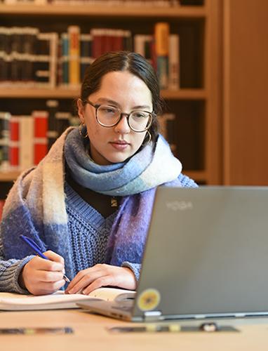Student studying with their laptop