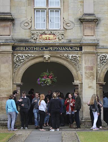Students having a garden party under the Pepys Building cloisters