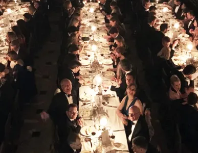Magdalene alumni dining in Hall by candlelight 