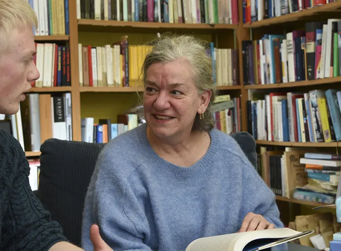 Student and tutor discussing a text book